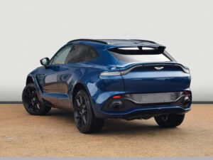 Rear three-quarter view of a blue Aston Martin DBX