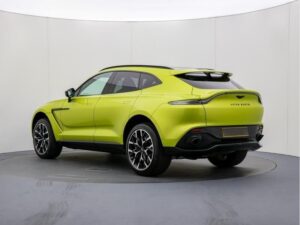 Rear three-quarter view of a yellow-green Aston Martin DBX