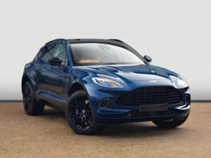 Front three-quarter view of a blue Aston Martin DBX