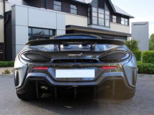 Rear view of a grey McLaren 600LT showing its fixed wing and twin top-exit exhausts