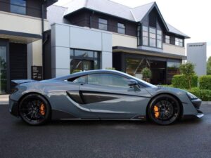 Side view of a grey McLaren 600LT with black wheels and orange brake calipers