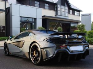 Rear three-quarter view of a grey McLaren 600LT with a fixed rear wing